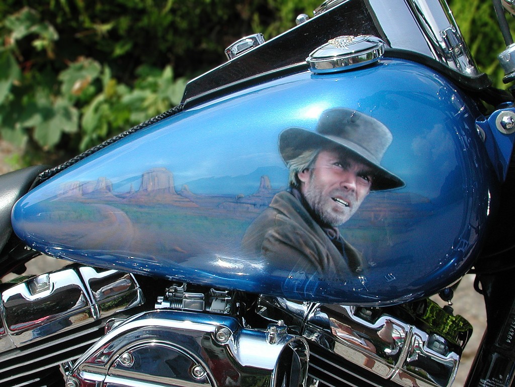 Clint Eastwood airbrushed onto a Harley Dyna with Monument valley background.