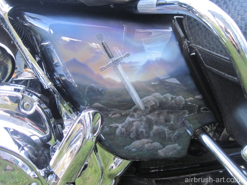 Side panel showing airbrush art of King Arthur sword and stone.
