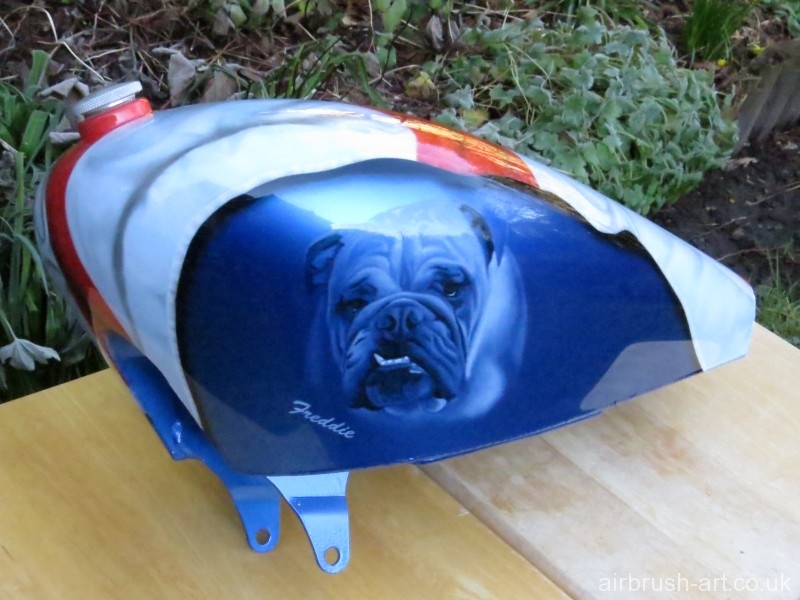 Family bulldog pet has been airbrushed onto metallic blue custom Harley tank.
