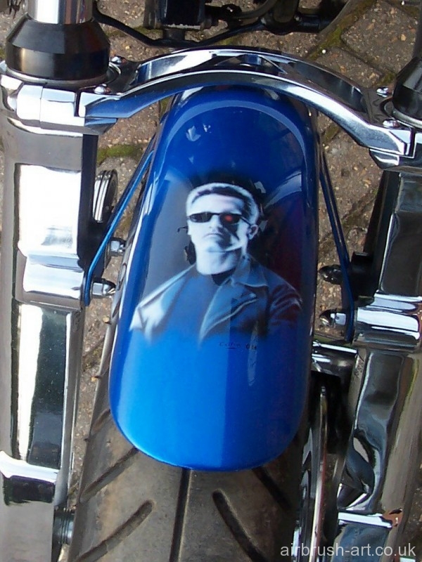 Arnold Schwarzenegger custom paint on motorcycle mudguard.