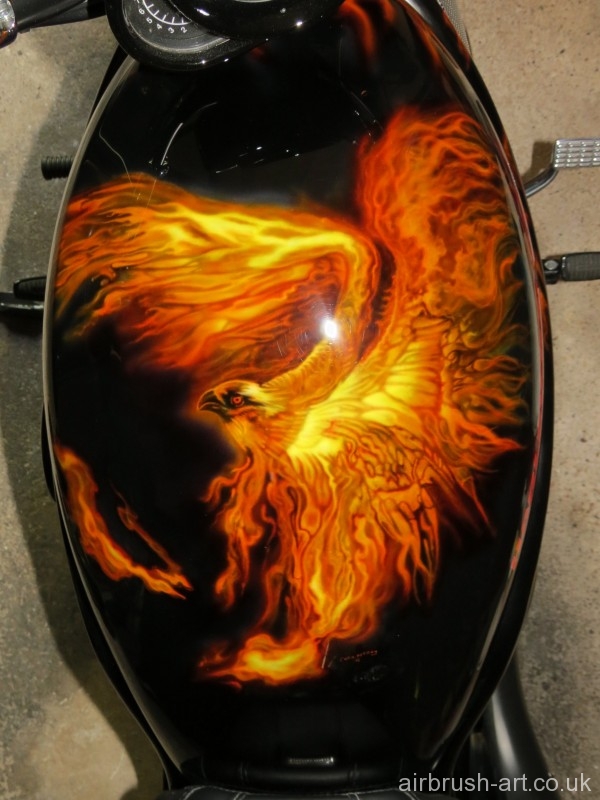An airbrushed flaming eagle on Harley Davidson tank.